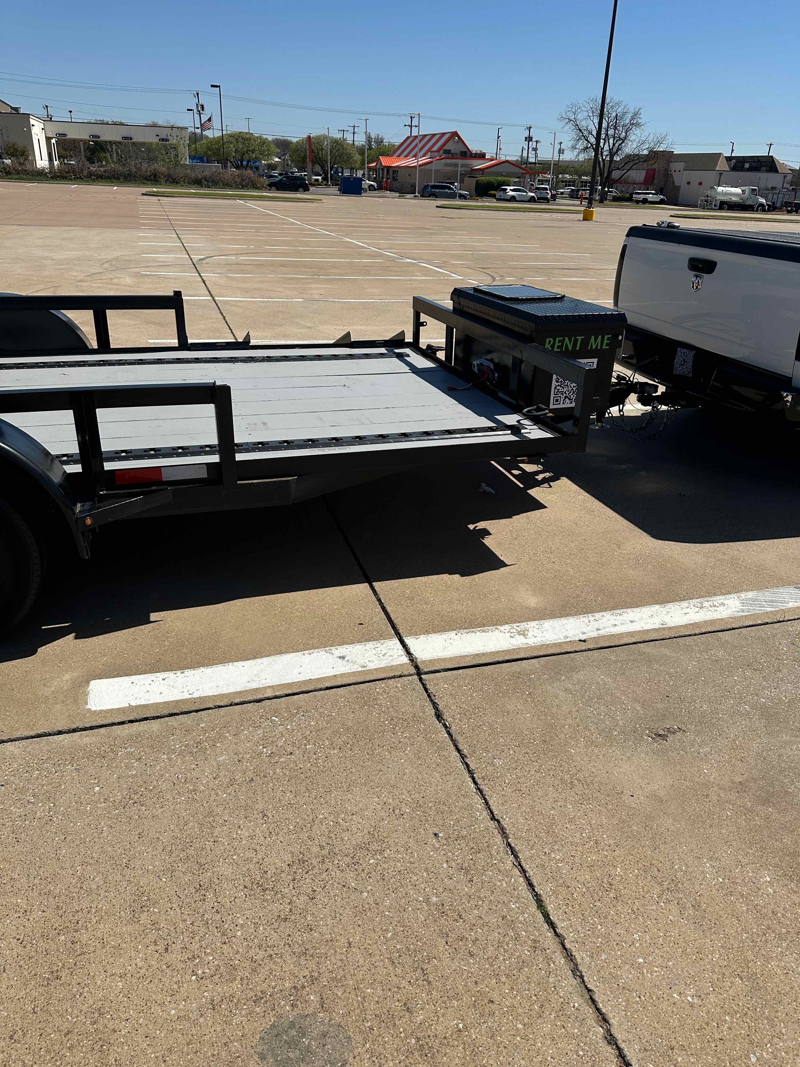 Side view of 2025 C&M 16ft utility trailer with wood deck and pipe rails